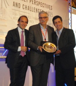 ASUTIL Vice President Marcelo Montico  (Grupo Wisa), on left, and ASUTIL Secretary  General Jose Luis Donagaray, on right, present Essence Corp.’s Jean-Jacques Bona with the 2015 Lifetime Achievement Award