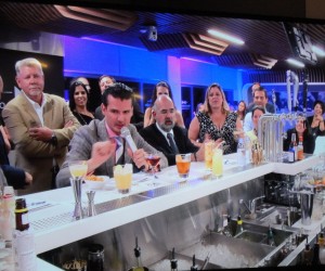 The judges critiquing cocktails under timed conditions, as Norwegian Cruises Lines’ Wes Cort, standing, looks on. 