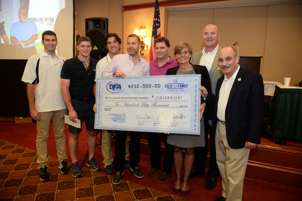 From left:  DFA’s Joseph and Dov Falic, Gabe Groisman, Leon and Jerome Falic symbolically hand over a check for $250,000 to Dr. Annette Bakker, William Brooks and Michael A. Divers of the Children’s Tumor Foundation at the conclusion of the 2nd DFA charity Golf Tournament on Sept. 10 at the Weston Hills Country Club. Special recognition to Diamond Sponsors Pernod Ricard Travel Retail Americas, Clarins and Moet Hennessy Travel Retail, and Platinum Sponsor Philip Morris Duty Free. 