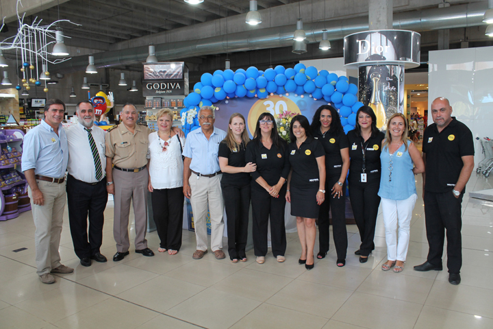 Neutral CEO Enrique Urioste, far left, and staff and guests, celebrate the border store’s 30th anniversary in festivities in one of the stores in the town of Chuy.