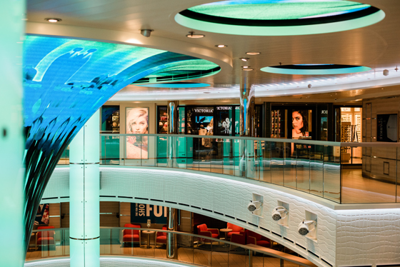 A three-story tall, digitally-decorated funnel with flashing designs greet passengers embarking on the new Carnival Horizon cruise ship, leading up the largest area dedicated to shopping on any Carnival ship. Starboard Cruise Services and Carnival have created a two-level shopping promenade rimming the ship’s atrium on decks 4 and 5, with branded shops boasting the largest and most varied offerings in the fleet with a stellar lineup of some of the most popular brands in the world.